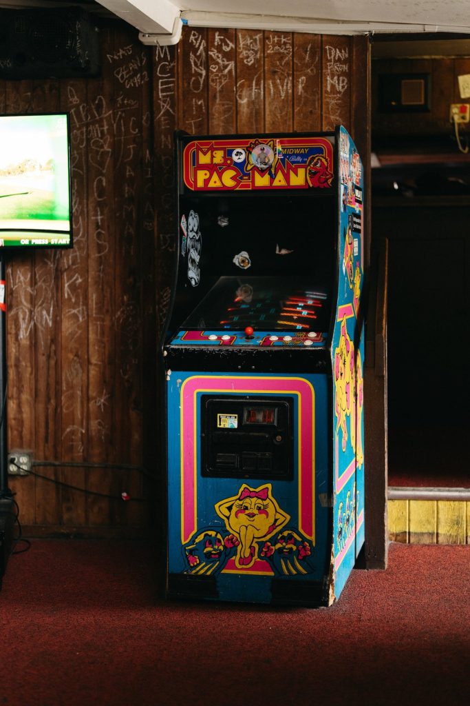 Ms. Pac-Man arcade cabinet against the wood-paneled wall at the Sandpiper Lounge